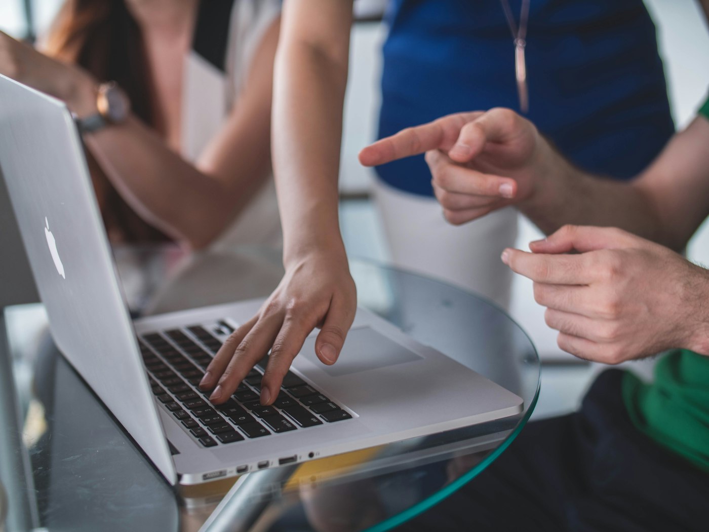 Two people reviewing work on a laptop